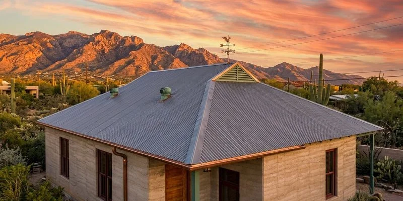 Beautiful desert home with a new metal roof against the Tucson mountain skyline at sunset