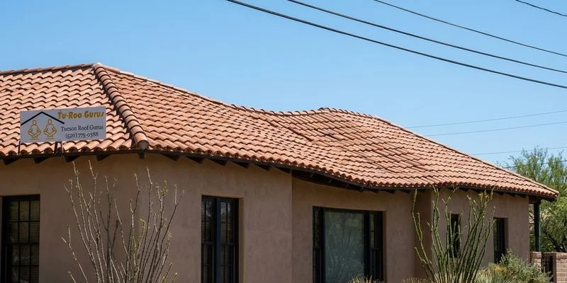 Side view of a Tucson home roof showing visible sagging along the roofline requiring urgent repair